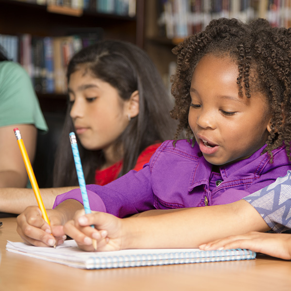 Children doing schoolwork in class